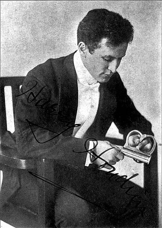 Black and white photograph of Harry Houdini seated with his chin on his hand