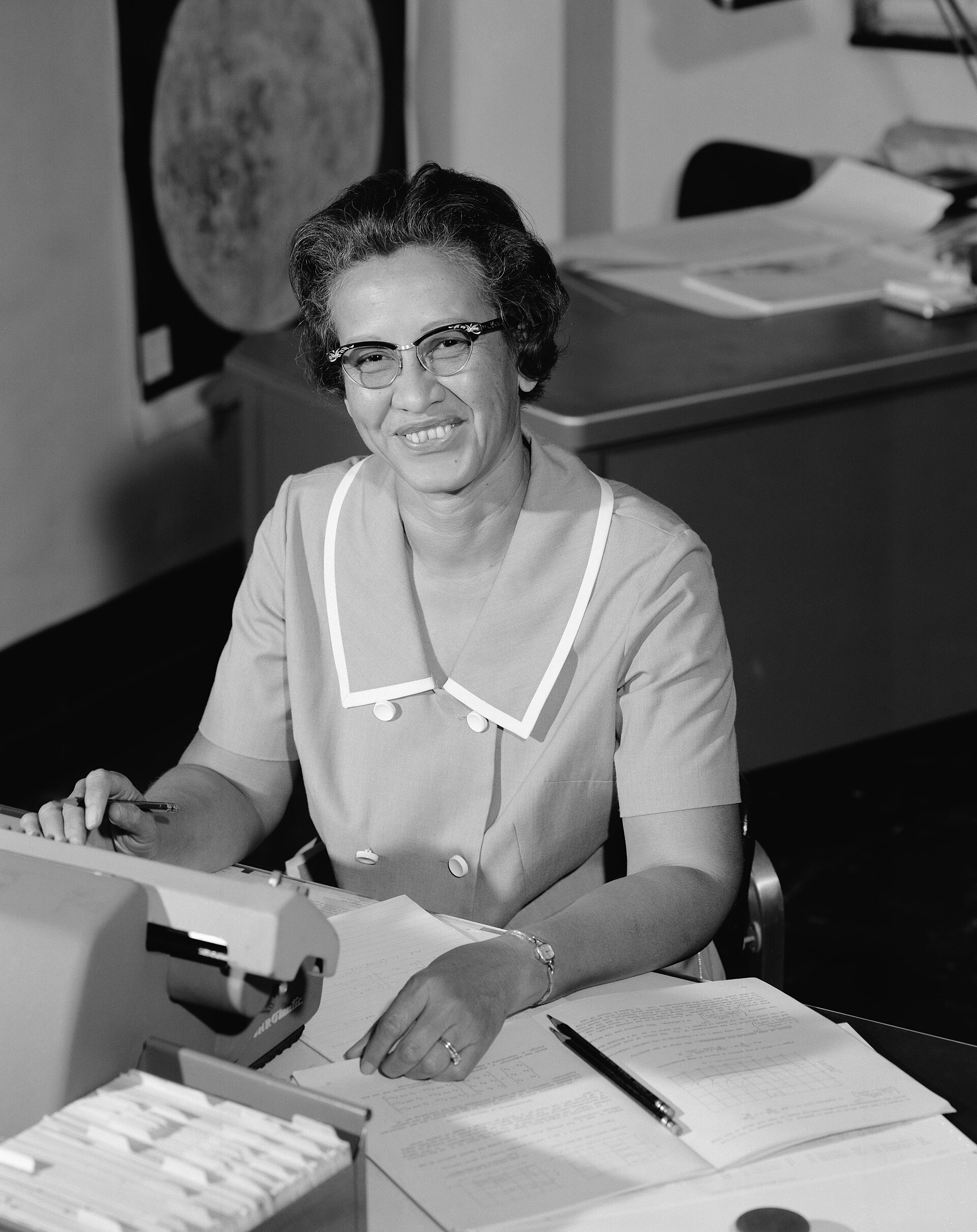 Katherine Johnson smiling at her desk at NASA Langley Research Center, 1966